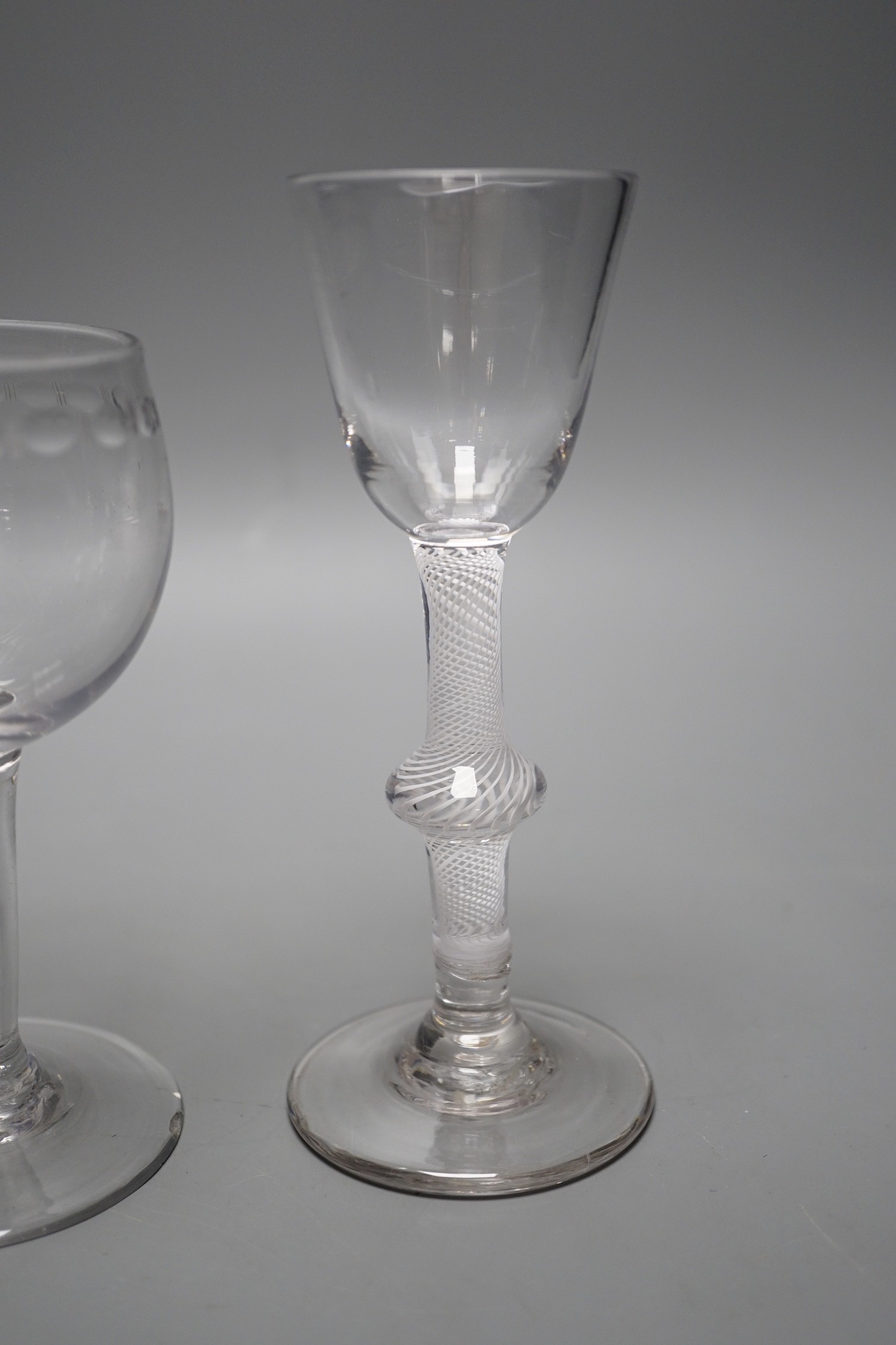 A George II mercury twist stem glass, a George III hollow stem glass, a toddy lifter and an air twist glass, tallest 17cm (4)